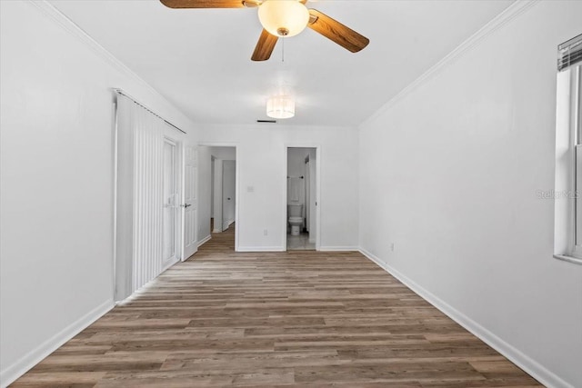 15118 Brushwood Dr, Tampa, FL 33624 - unfurnished bedroom with wood finished floors, baseboards, connected bathroom, ornamental molding, and a ceiling fan