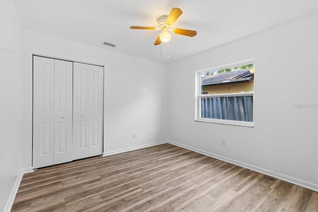 15118 Brushwood Dr, Tampa, FL 33624 - unfurnished bedroom featuring wood finished floors and baseboards