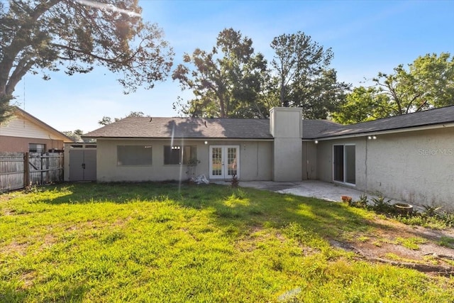 15118 Brushwood Dr, Tampa, FL 33624 - rear view of property with french doors, a chimney, a patio, and stucco siding