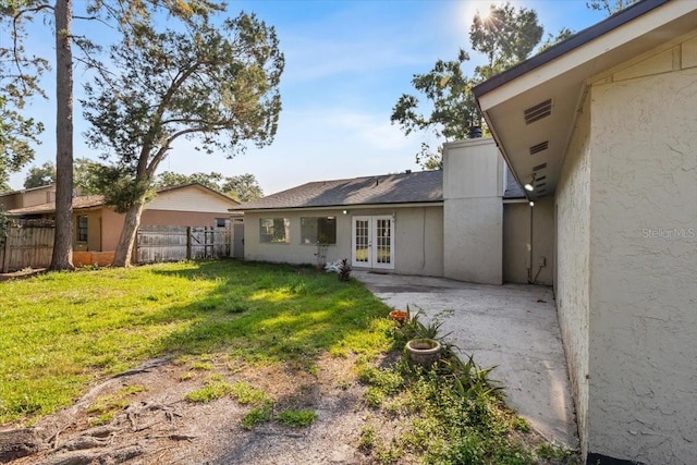 15118 Brushwood Dr, Tampa, FL 33624 - back of property with french doors, stucco siding, and a patio