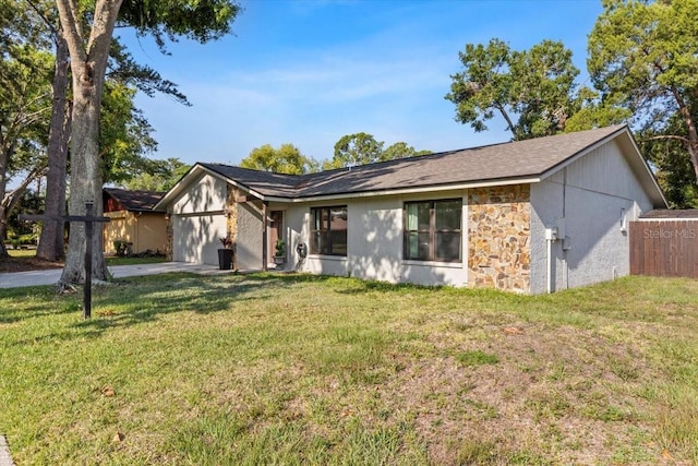 15118 Brushwood Dr, Tampa, FL 33624 - view of front of home with an attached garage, a front yard, stone siding, and concrete driveway