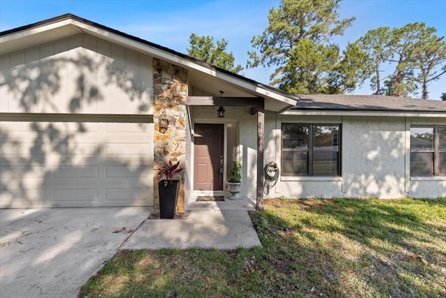 15118 Brushwood Dr, Tampa, FL 33624 - view of front of house with a garage, driveway, stucco siding, stone siding, and a front lawn