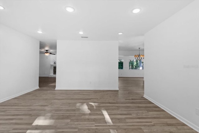 15118 Brushwood Dr, Tampa, FL 33624 - empty room featuring a chandelier, recessed lighting, wood finished floors, a ceiling fan, and baseboards