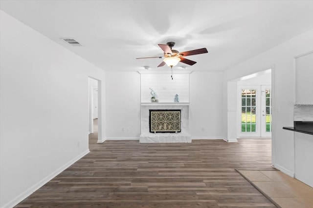 15118 Brushwood Dr, Tampa, FL 33624 - unfurnished living room featuring a ceiling fan, wood finished floors, a fireplace, and baseboards
