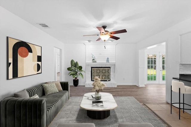 15118 Brushwood Dr, Tampa, FL 33624 - living room with ceiling fan, wood finished floors, a high end fireplace, and baseboards