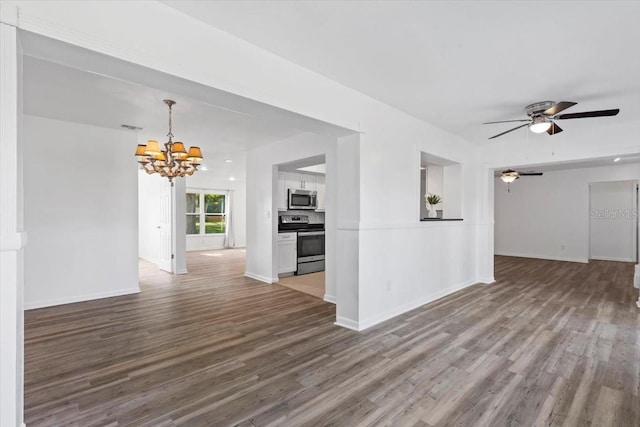 15118 Brushwood Dr, Tampa, FL 33624 - unfurnished living room with a chandelier, wood finished floors, ceiling fan, and baseboards