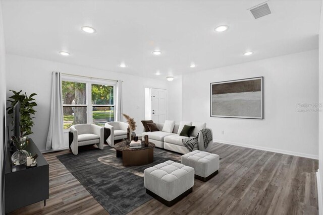 15118 Brushwood Dr, Tampa, FL 33624 - living room with dark wood-style floors and recessed lighting