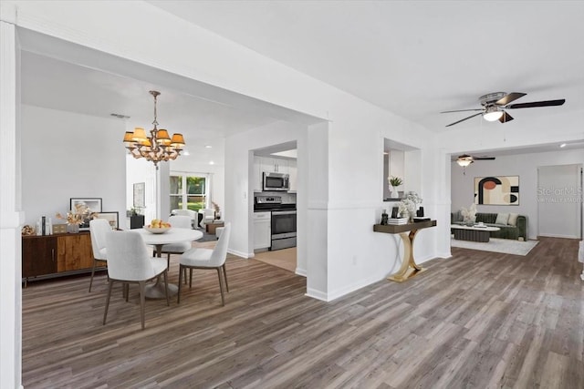 15118 Brushwood Dr, Tampa, FL 33624 - dining area with wood finished floors, a chandelier, ceiling fan, and baseboards