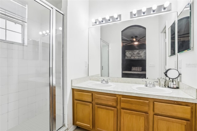 bathroom featuring a stall shower and double vanity