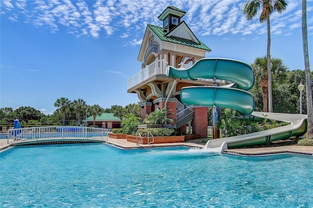 community pool featuring a water slide