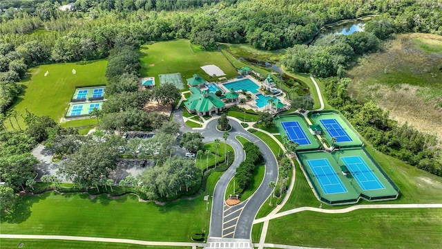 aerial view of property's location featuring a forest and a pool area