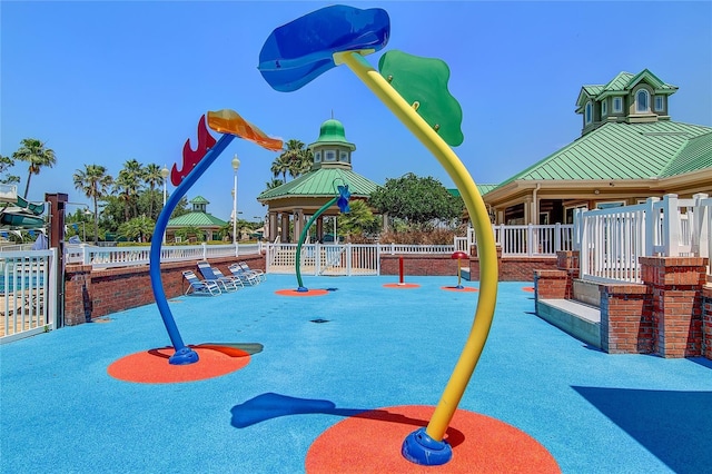 view of playground featuring a gazebo and fence