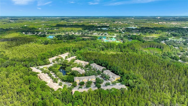 aerial view of property's location featuring a forest