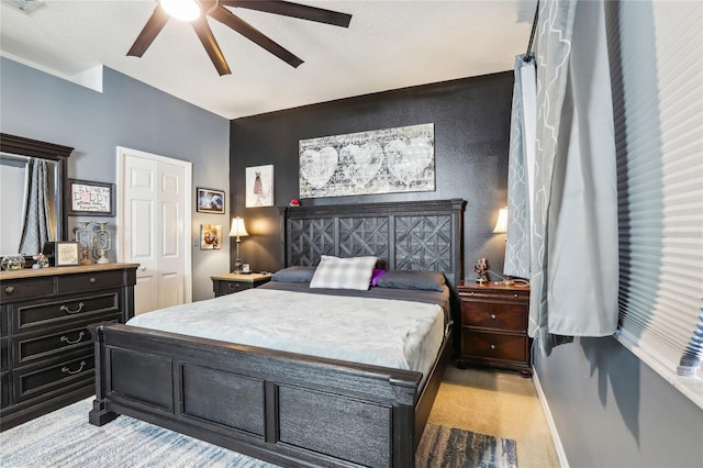 bedroom featuring a ceiling fan, light colored carpet, and baseboards