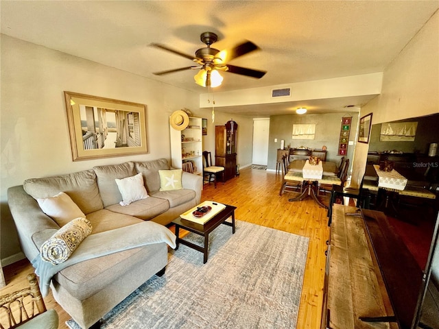 825 S Village Dr N Unit 201, Saint Petersburg, FL 33716 - living area featuring light wood-style flooring, a ceiling fan, and baseboards