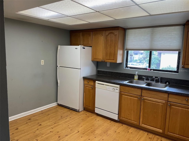 825 S Village Dr N Unit 201, Saint Petersburg, FL 33716 - kitchen featuring white appliances, a sink, light wood-type flooring, and dark countertops