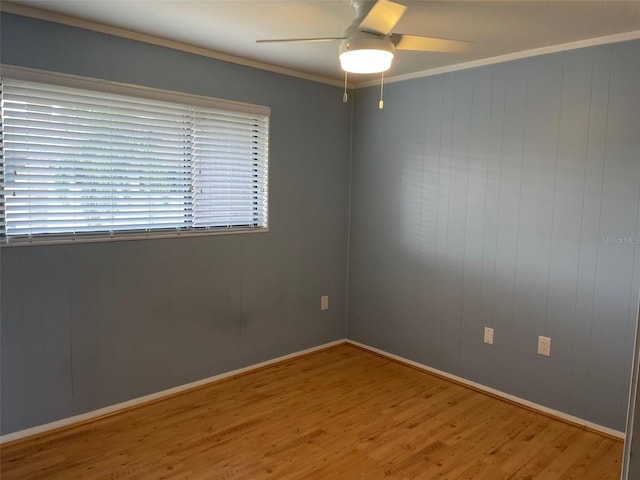 825 S Village Dr N Unit 201, Saint Petersburg, FL 33716 - unfurnished room featuring wood finished floors, ceiling fan, crown molding, and baseboards