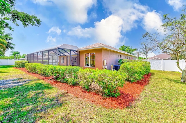 2250 Mountain Ash Way, New Port Richey, FL 34655 - back of house with stucco siding, glass enclosure, and central AC
