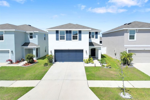 view of front facade with stucco siding, driveway, a front yard, and a garage