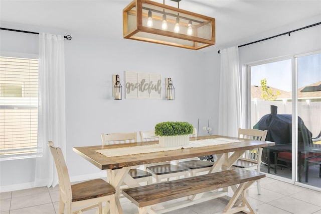dining room with light tile patterned flooring and baseboards