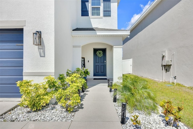 view of exterior entry with stucco siding