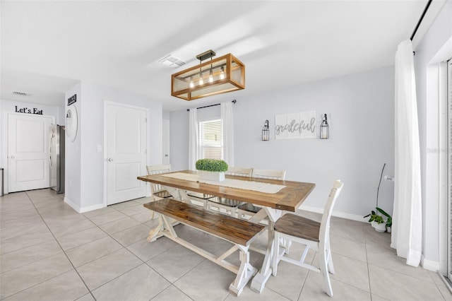 dining space featuring baseboards, visible vents, and light tile patterned flooring