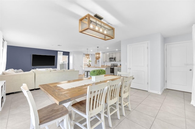 dining space with baseboards, recessed lighting, and light tile patterned flooring