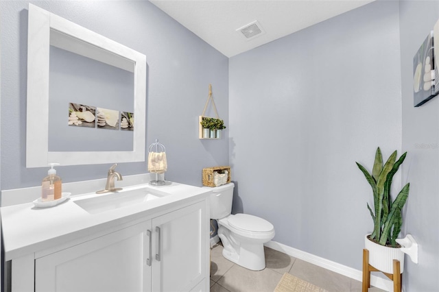 half bathroom featuring tile patterned floors, visible vents, toilet, vanity, and baseboards