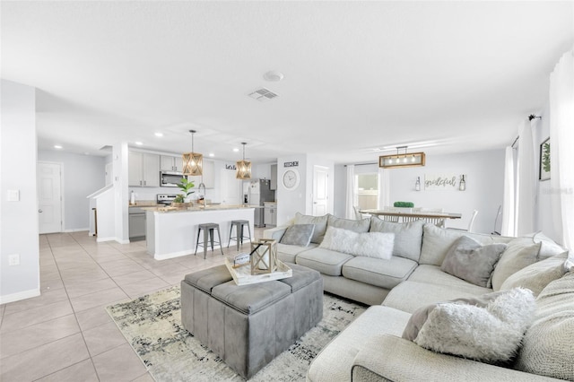 living room with recessed lighting, visible vents, baseboards, and light tile patterned floors