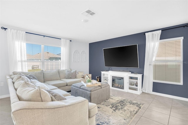 living room with visible vents, tile patterned floors, and baseboards