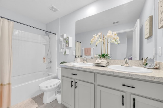 bathroom featuring tile patterned floors, visible vents, a sink, and toilet