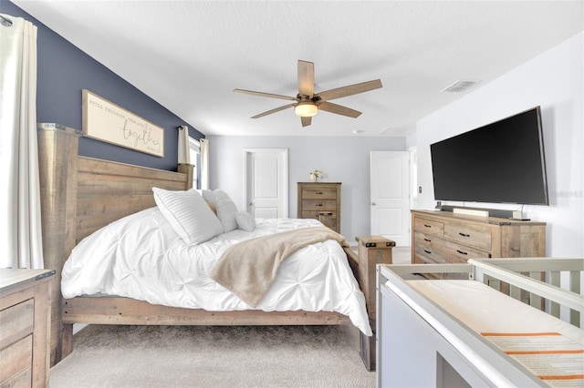 bedroom with visible vents, carpet flooring, and a ceiling fan