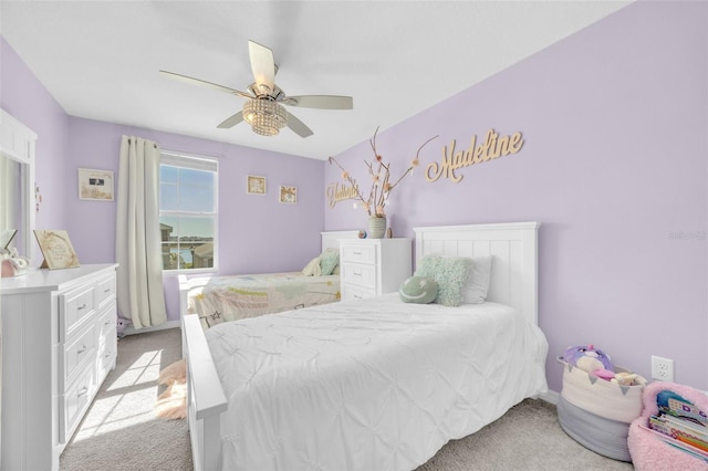 bedroom with light carpet and a ceiling fan