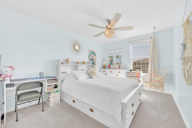 carpeted bedroom with baseboards and a ceiling fan