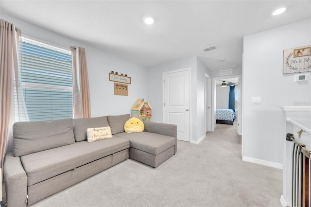 living area with recessed lighting, visible vents, light carpet, baseboards, and ceiling fan