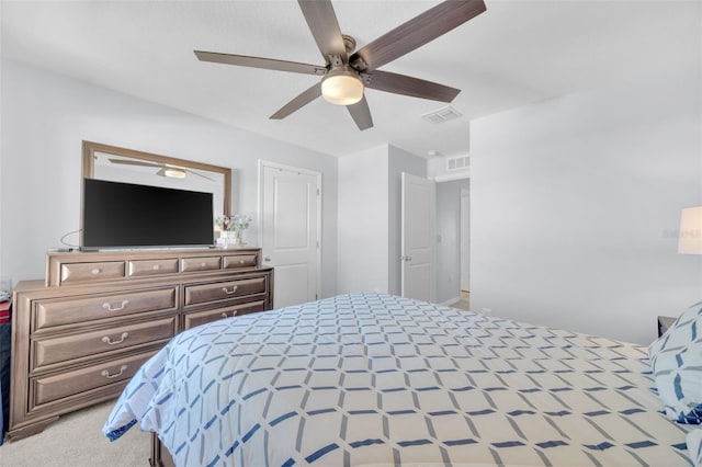 bedroom featuring light colored carpet, ceiling fan, and visible vents