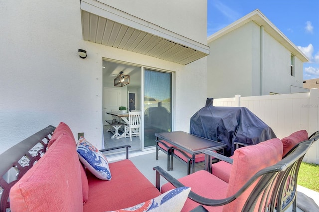 view of patio / terrace featuring a grill and fence