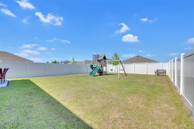 view of yard with a fenced backyard and a playground