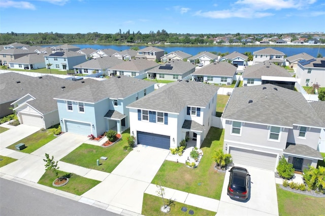 birds eye view of property with a water view and a residential view