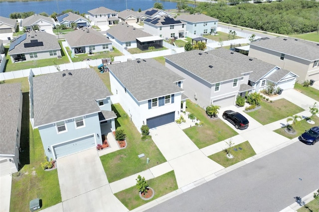 drone / aerial view featuring a water view and a residential view