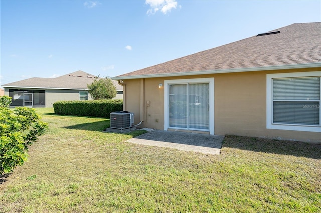 4235 Angelica Loop, Wesley Chapel, FL 33543 - back of property featuring central air condition unit, stucco siding, a lawn, and a shingled roof