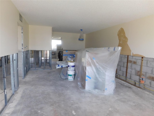 4715 Bay St NE Unit 119, Saint Petersburg, FL 33703 - misc room with visible vents, unfinished concrete flooring, and a textured ceiling