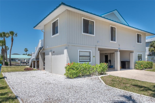 view of front of house with stairs and metal roof