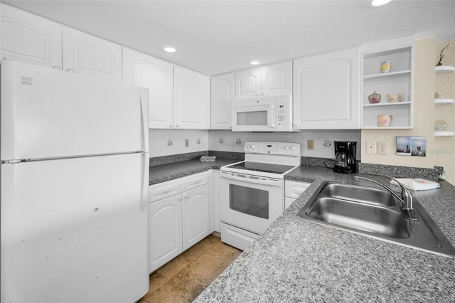 kitchen with a sink, dark countertops, recessed lighting, white cabinetry, and white appliances