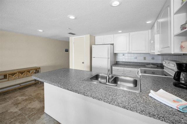 kitchen featuring white cabinets, open shelves, dark countertops, a sink, and white appliances