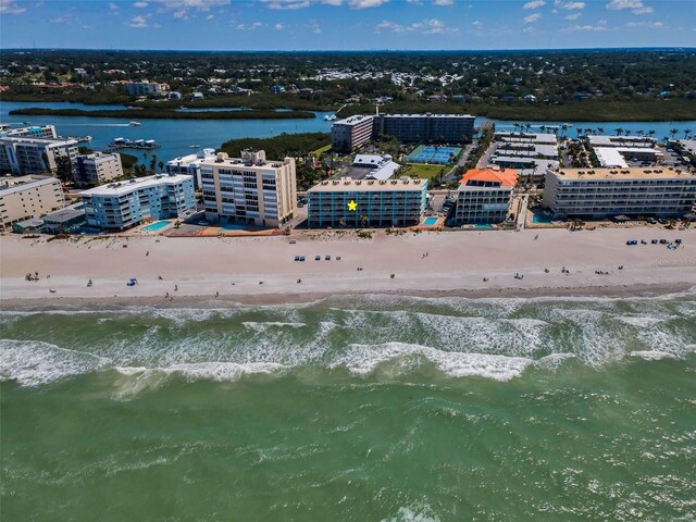 birds eye view of property with a view of the beach and a water view