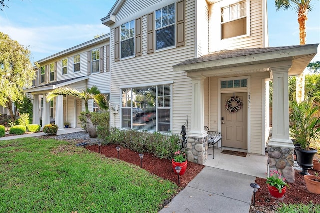 13777 Forest Lake Dr, Largo, FL 33771 - view of front of property featuring a front lawn, roof with shingles, and a porch