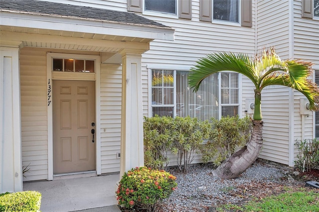 13777 Forest Lake Dr, Largo, FL 33771 - doorway to property with a shingled roof