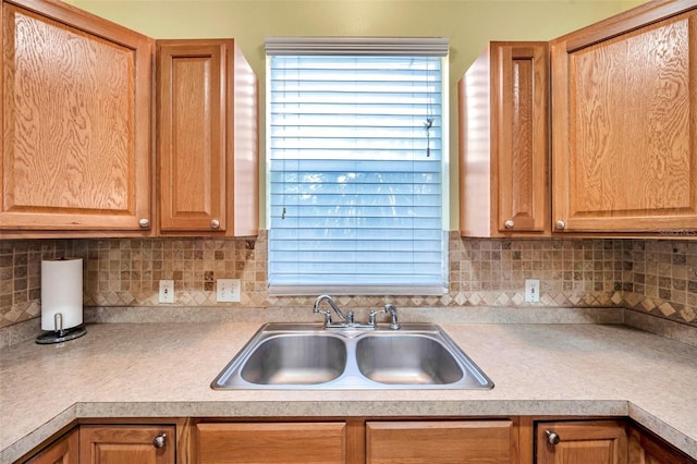 13777 Forest Lake Dr, Largo, FL 33771 - kitchen with decorative backsplash, light countertops, and a sink