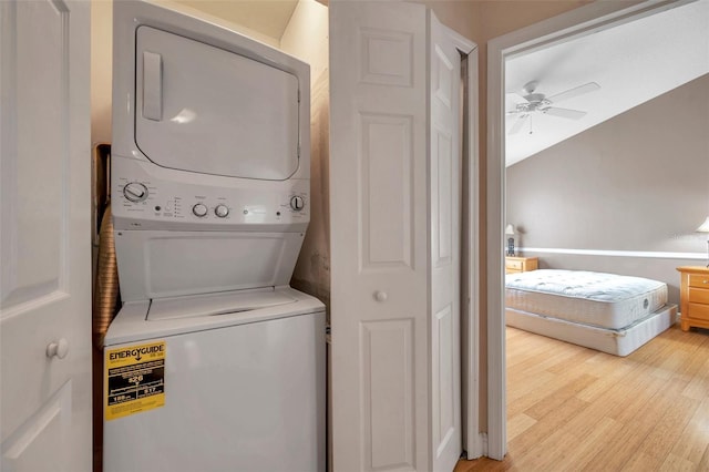 13777 Forest Lake Dr, Largo, FL 33771 - laundry room with a ceiling fan, stacked washer and dryer, laundry area, and light wood-style flooring